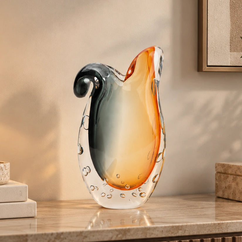 Glass vase with gradient color from gray to orange on a white background