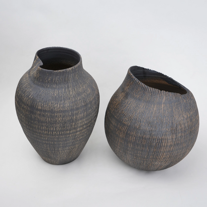 Two dark brown ceramic vases on a light gray background