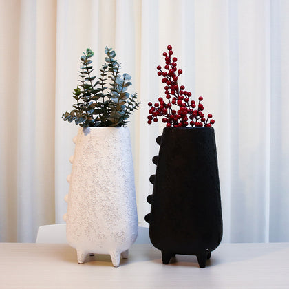 Artistic white and black flower vase with raised textured detailing displayed as a contemporary tabletop decor accent