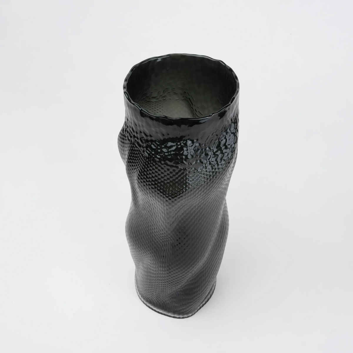 Textured art glass vase with flowing sculptural form and dimensional surface detailing