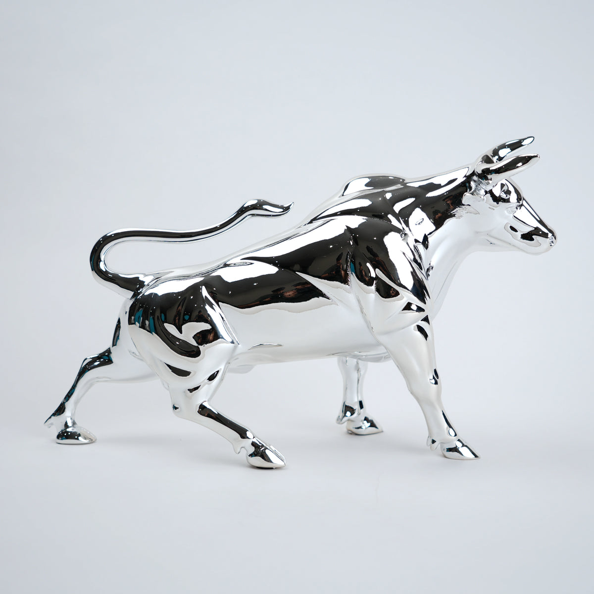 Chrome bull statue on a white background