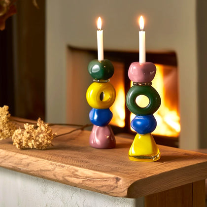 Totem holder pair lit on oak mantel