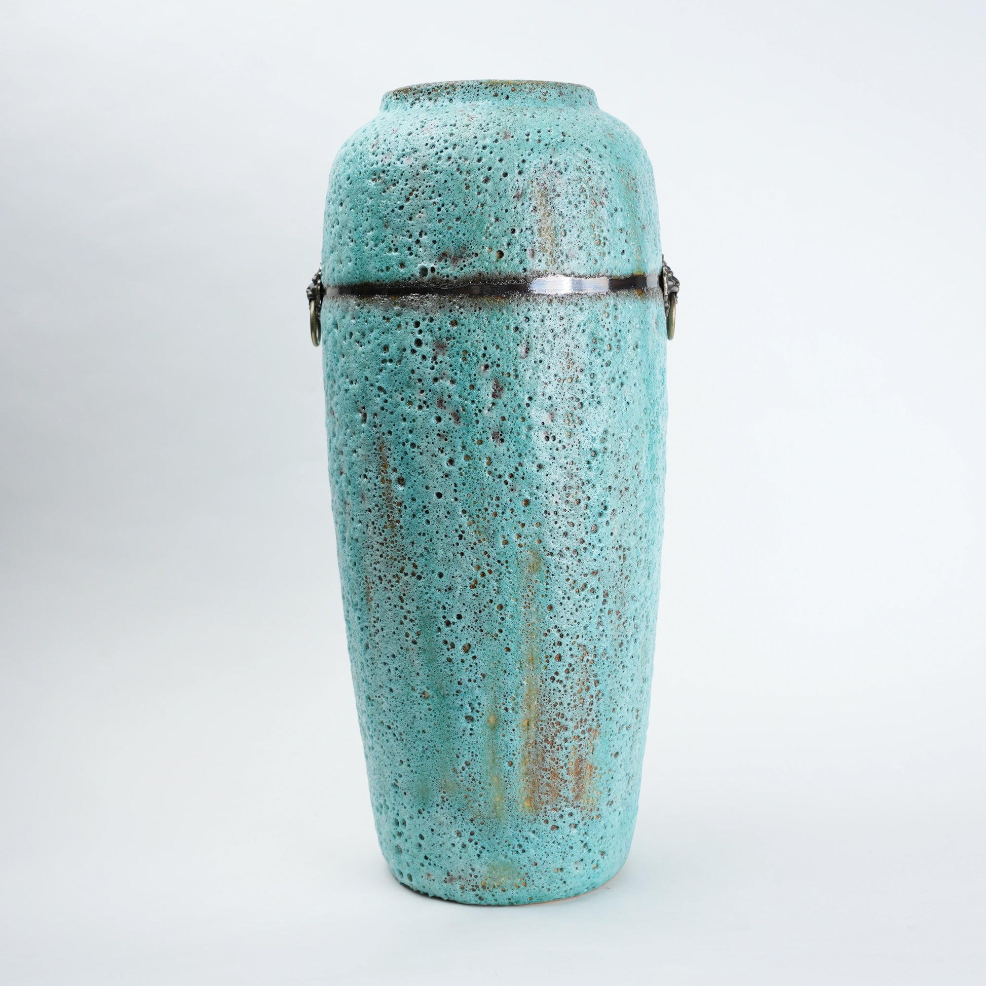 Turquoise ceramic urn with decorative patterns on a white background