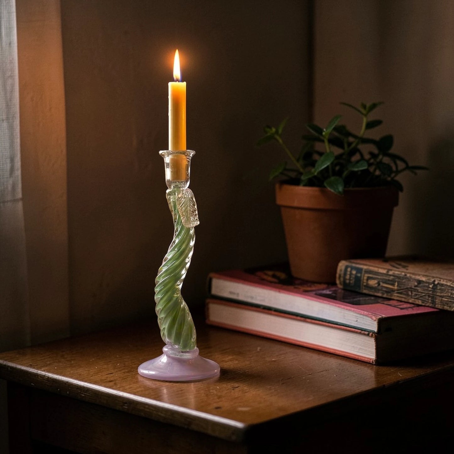 Tall Twist Glow holder lit on desk w/ books