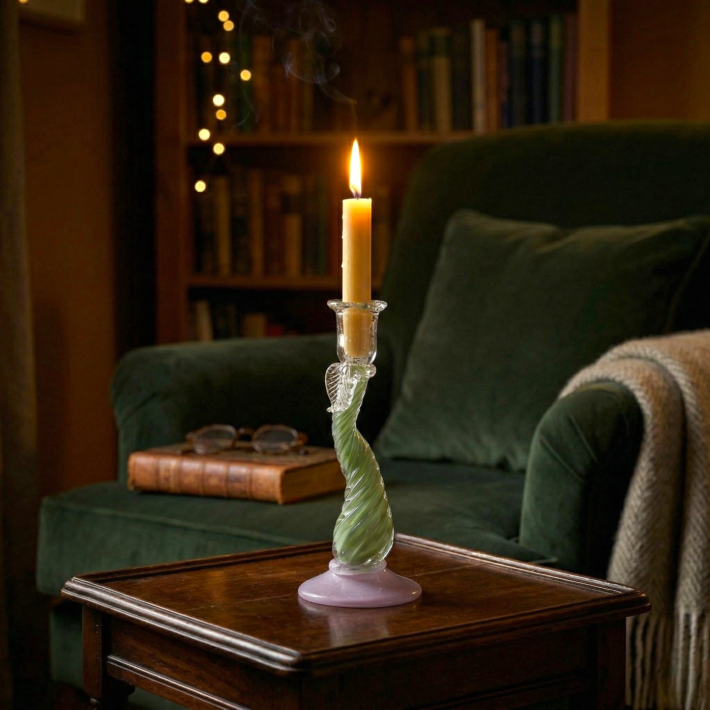 Twist Glow holder lit by velvet armchair
