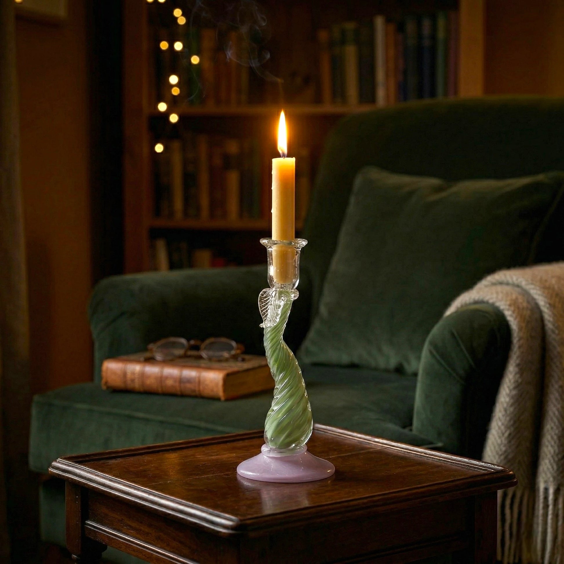 Twist Glow holder lit by velvet armchair
