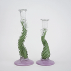 Two glass candle holders with green spiral designs on a white background