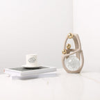 Golden Orb Accent on marble w/ books & cup