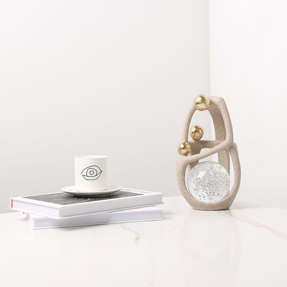 Golden Orb Accent on marble w/ books & cup