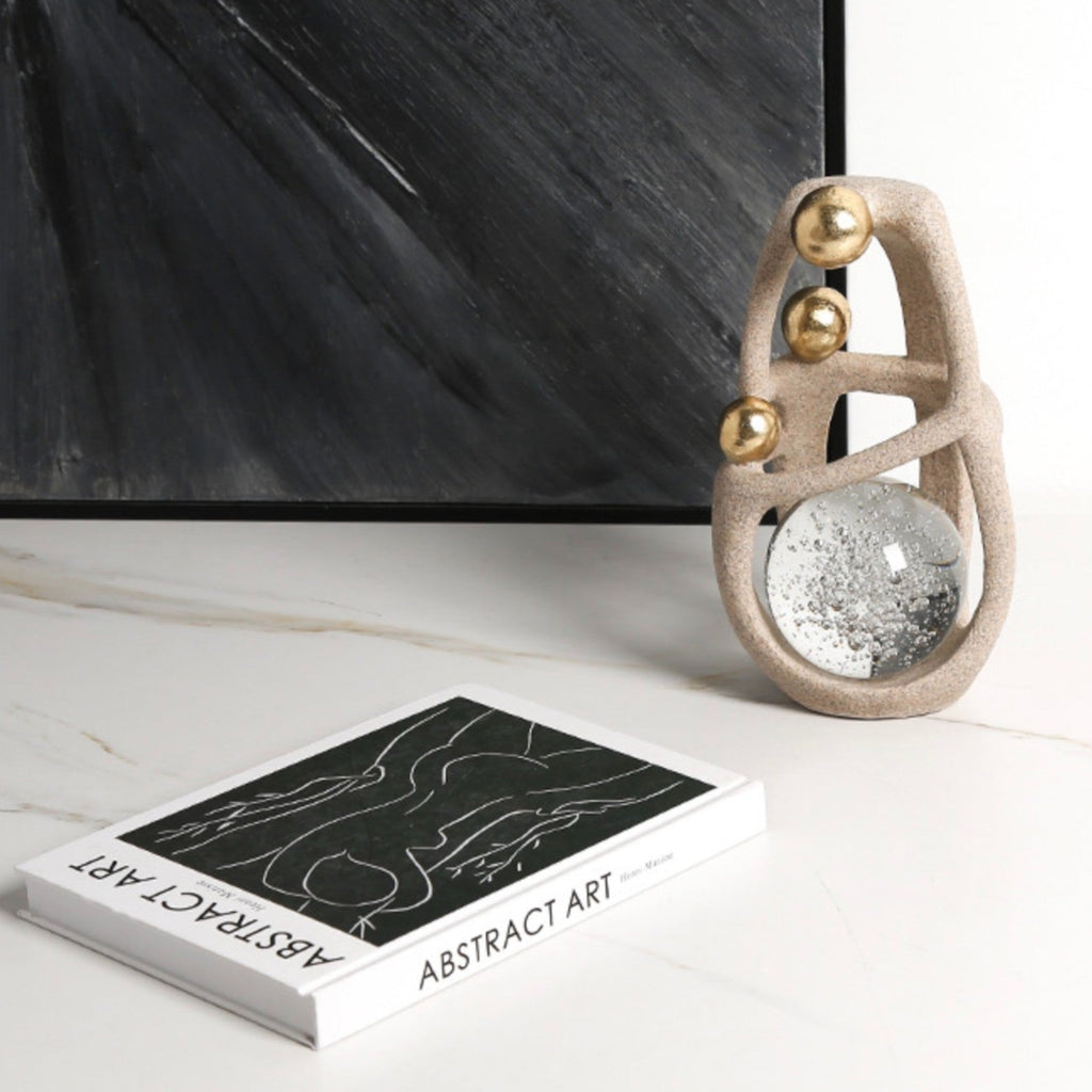 Golden Orb Accent beside black painting