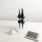 Noir column on white desk w/ teacup