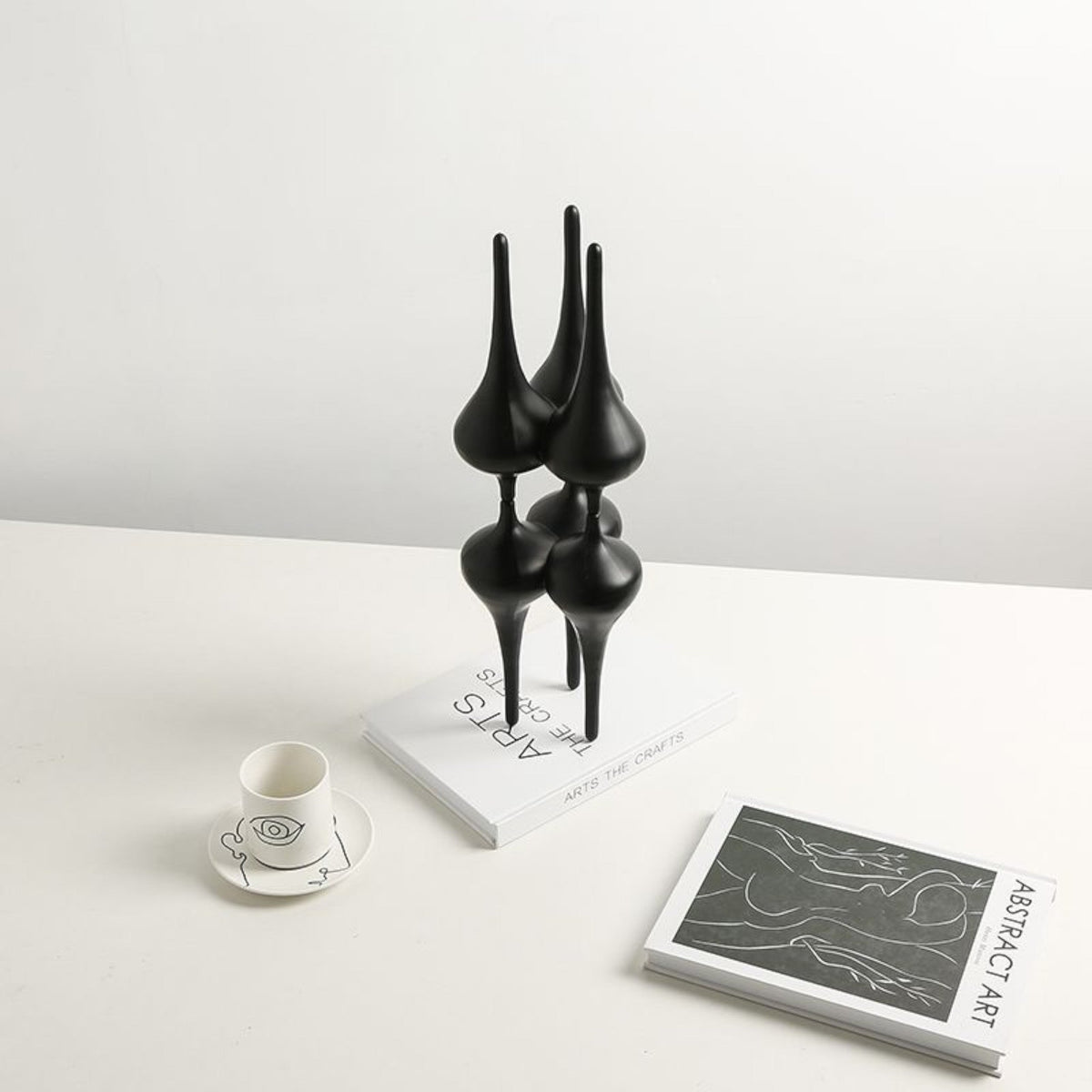 Noir column on white desk w/ teacup