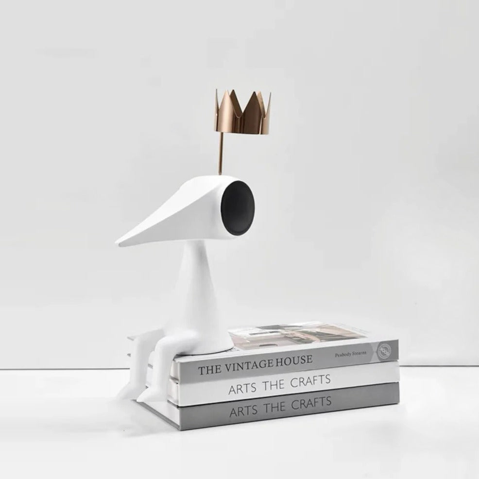 Gold crowned figure on art books, styled