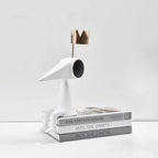 Gold crowned figure on art books, styled