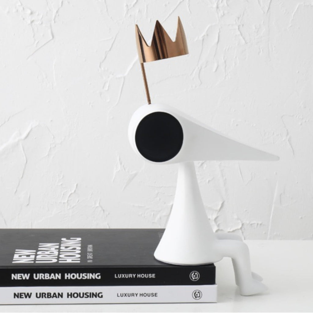 Gold crowned figure on architecture books, profile