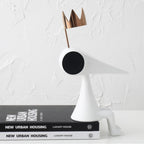 Gold crowned figure on architecture books, profile