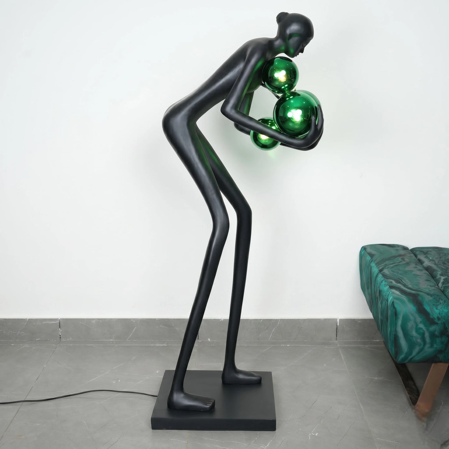 Glow figure lamp, green lit, velvet sofa