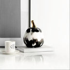 NoirLuxe pumpkin beside espresso cup