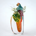 Glass vase with a parrot design and floral elements on a white background