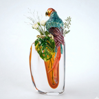 Glass vase with a parrot design and floral elements on a white background
