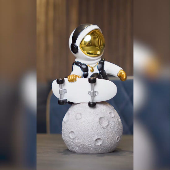 white cosmic skater astronaut figurine sitting on moon with skateboard