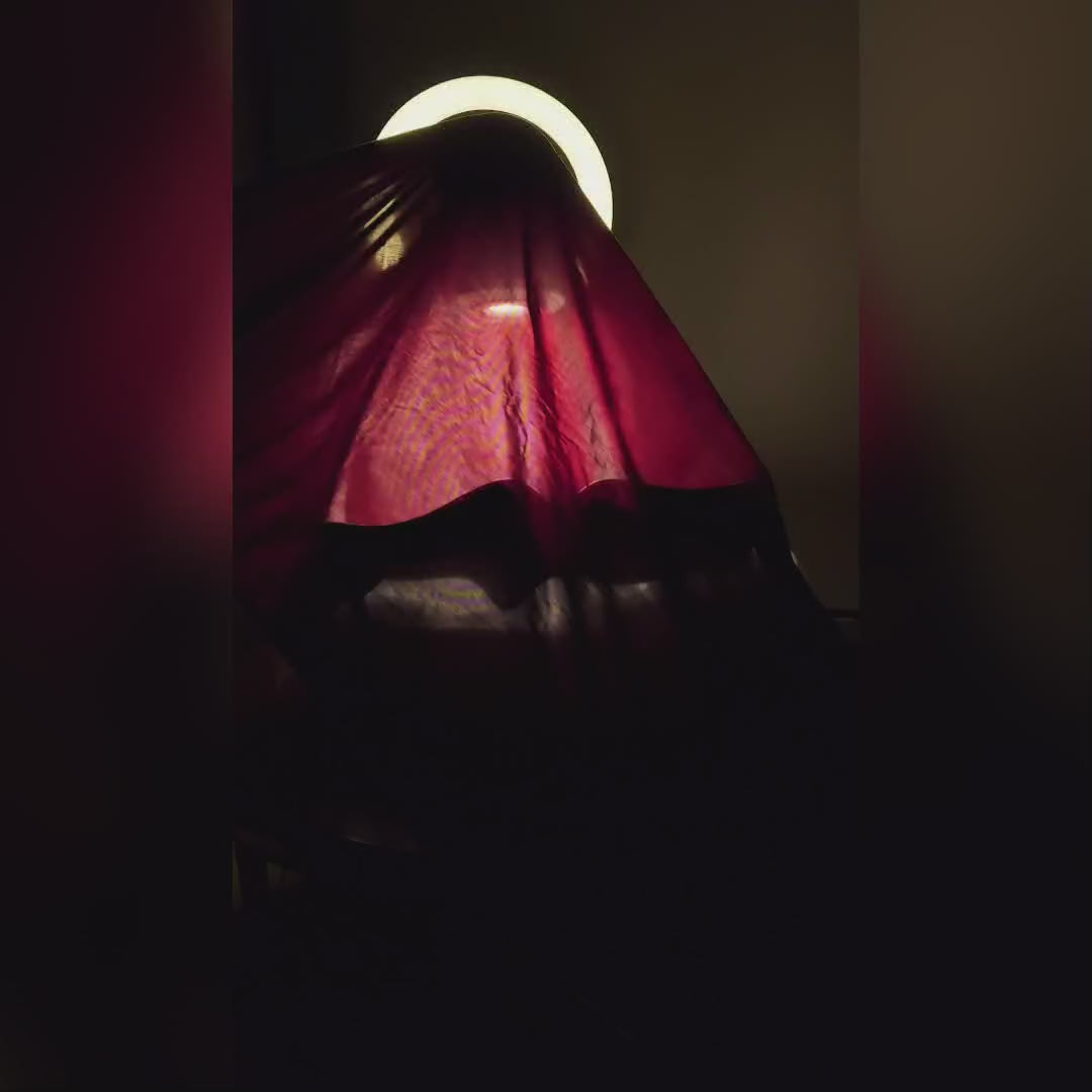 Glossy white reading sculpture lamp with abstract seated figure holding a book and built-in LED light.