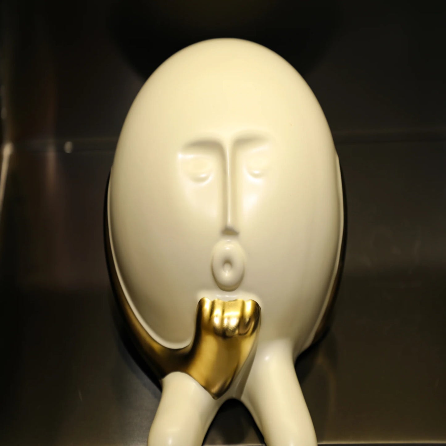 Regal Gaze: White & Gold Face Figurine