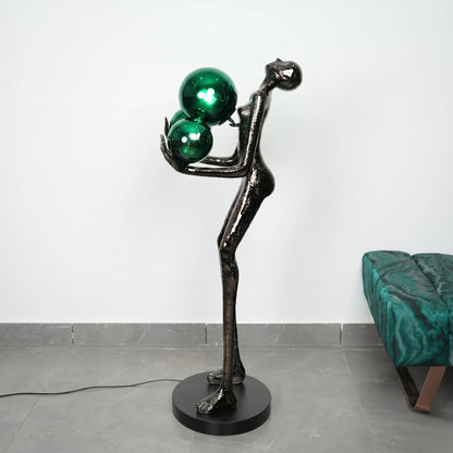 Modern floor lamp with green glass spheres on a white background