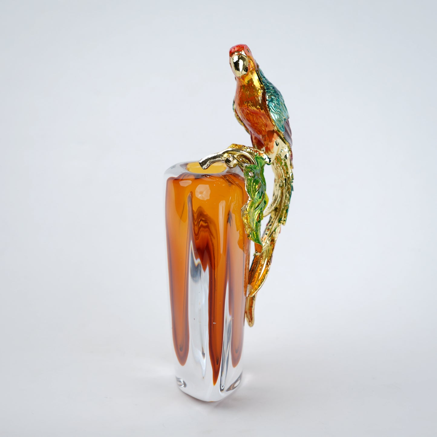 Modern decorative vase with colorful bird design and warm amber glass center