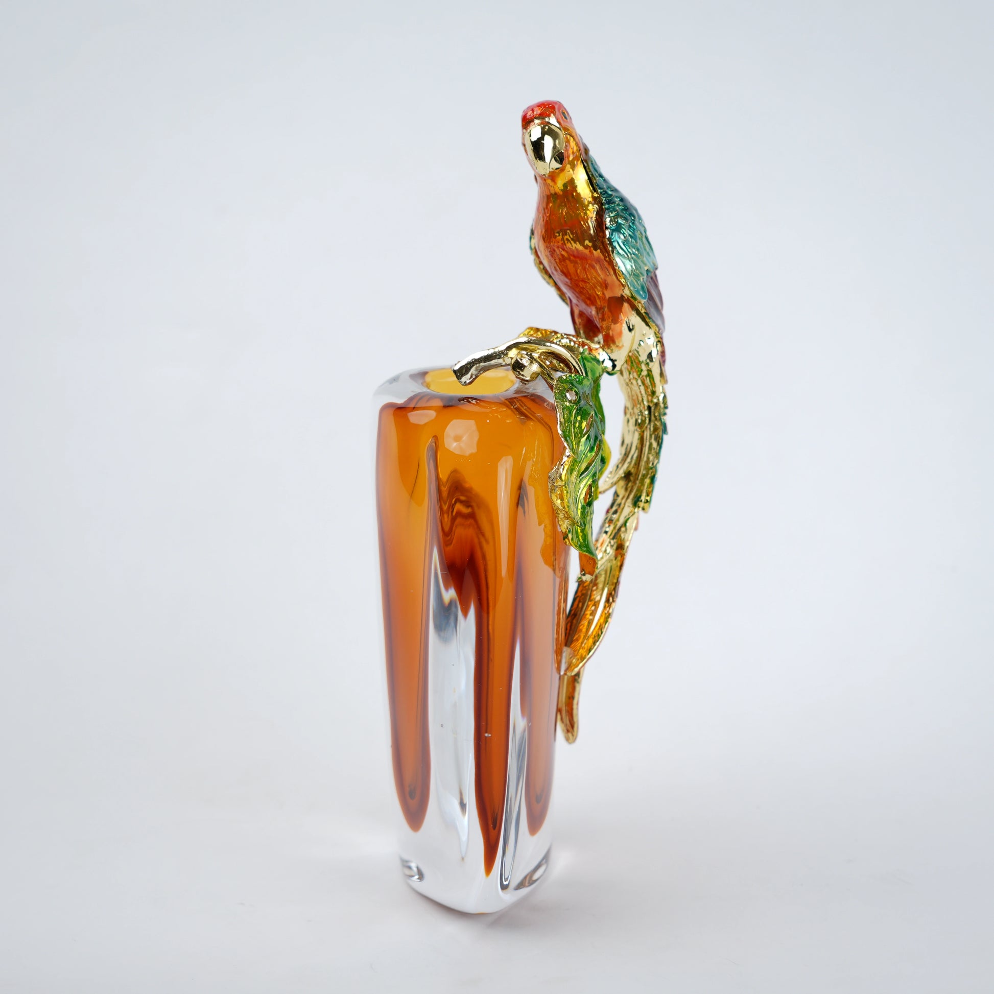Modern decorative vase with colorful bird design and warm amber glass center