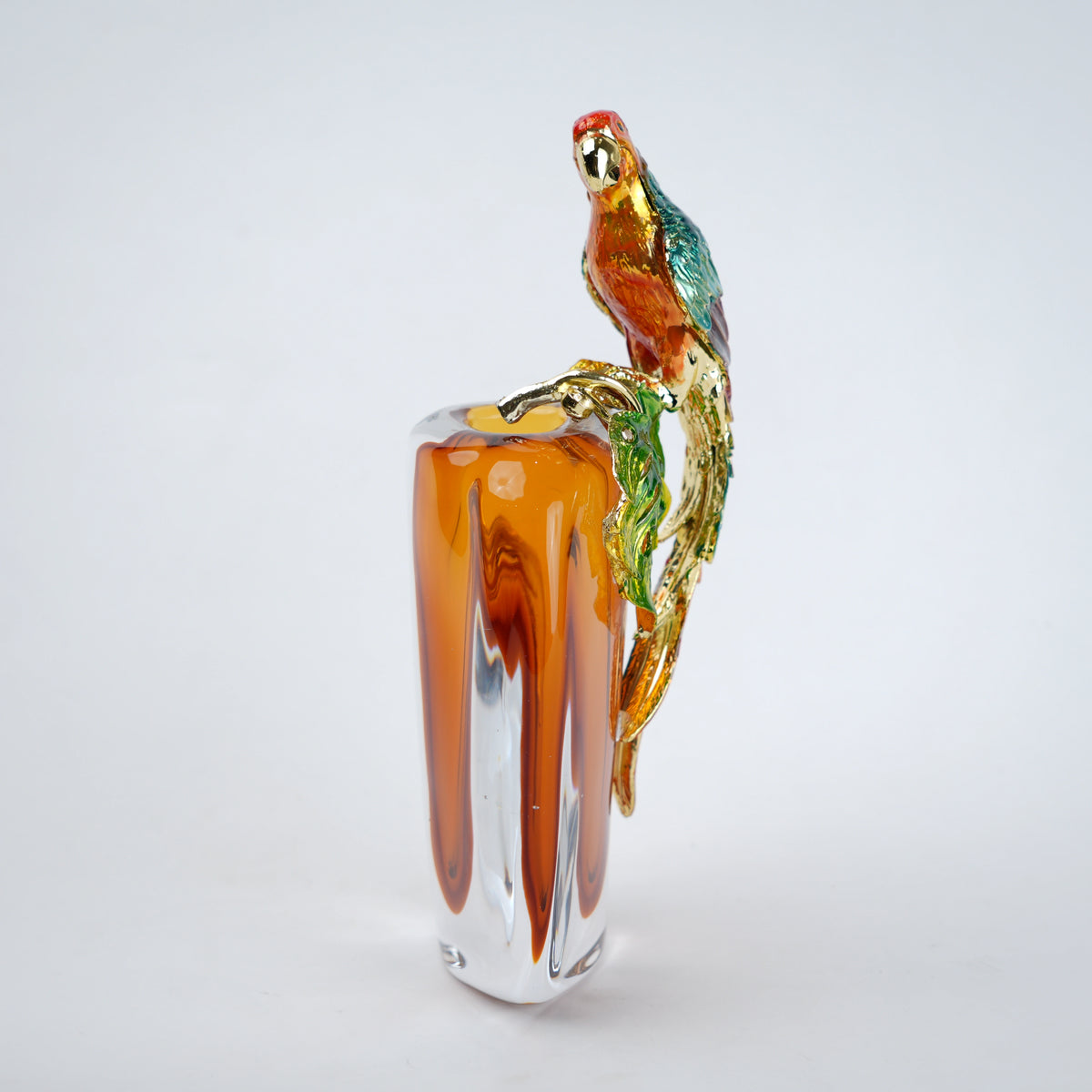 Modern decorative vase with colorful bird design and warm amber glass center