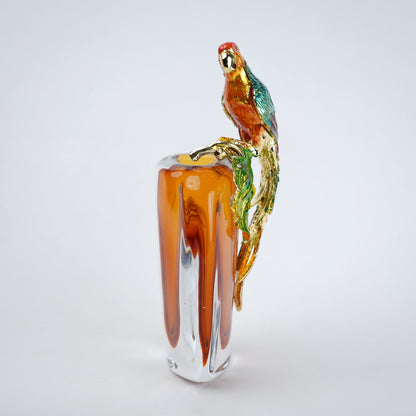 Modern decorative vase with colorful bird design and warm amber glass center
